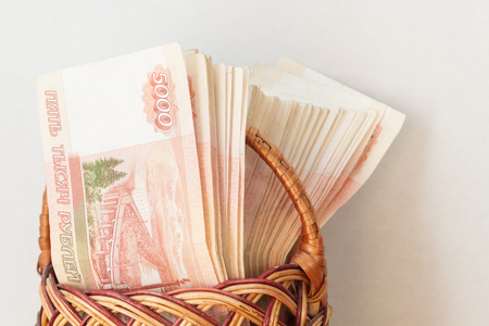 A lot of Russian money in denominations of five thousand rubles are in the basketの写真素材