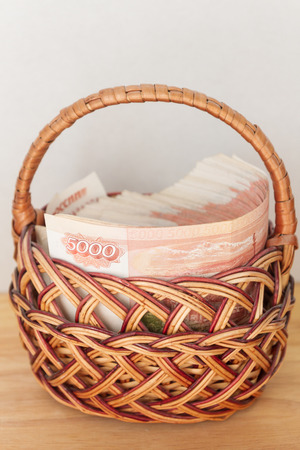 A lot of Russian money in denominations of five thousand rubles are in the basketの写真素材