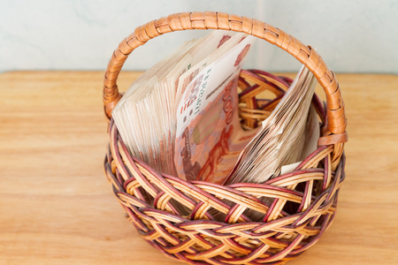 A lot of Russian money in denominations of five thousand rubles are in the basketの写真素材