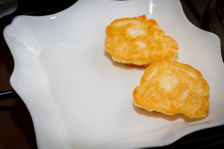 Cooking pancakes on a black pan with oil