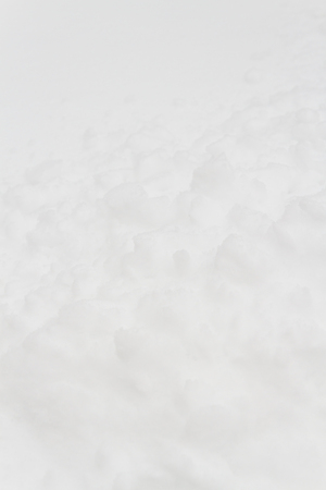 White fluffy snow lies on the ground in winterの写真素材