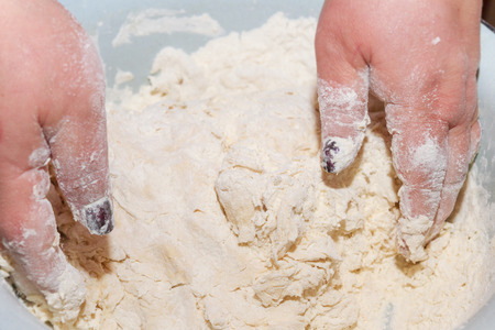 Mix the dough with your hands in a bowlの写真素材
