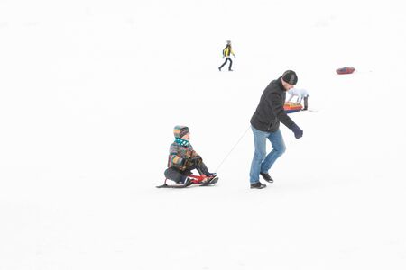 Alexandria Park, Peterhof, St. Petersburg, Russia 04 January 2019. Winter fun skiing with snow slides parents and children.のeditorial素材