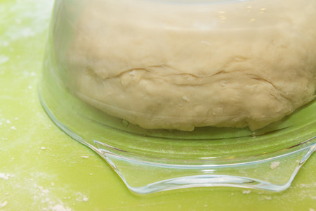 The raw dough is infused under a glass plate for making homemade dumplingsの写真素材
