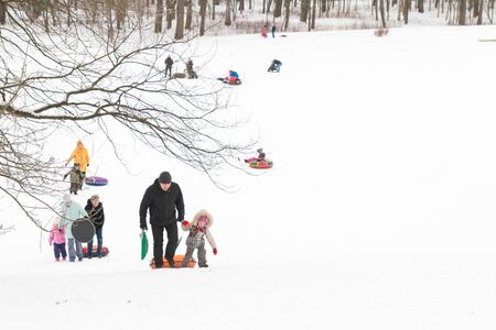 Alexandria Park, Peterhof, St. Petersburg, Russia 04 January 2019. Winter fun skiing with snow slides parents and children.のeditorial素材