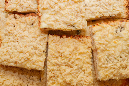 Freshly baked sand cake cut into pieces lie on top of each otherの写真素材