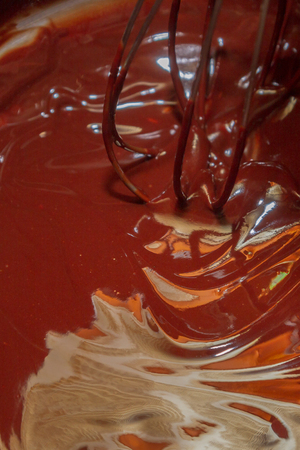 Thorough mixing of the liquid chocolate for dessert cookingの写真素材