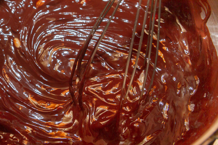 Thorough mixing of the liquid chocolate for dessert cookingの写真素材