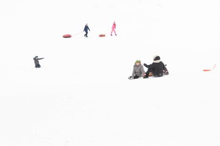 Alexandria Park, Peterhof, St. Petersburg, Russia 04 January 2019. Winter fun skiing with snow slides parents and children.のeditorial素材