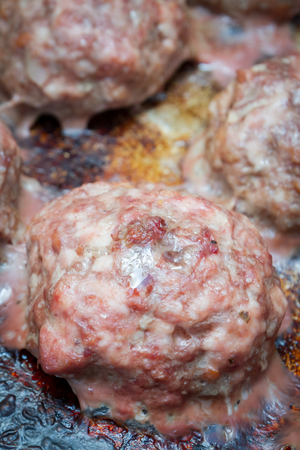 Meat cutlets cooked on a baking sheet in the ovenの写真素材