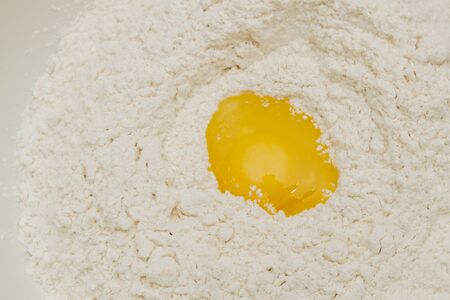 Cooking dough in a white plastic bowl at home