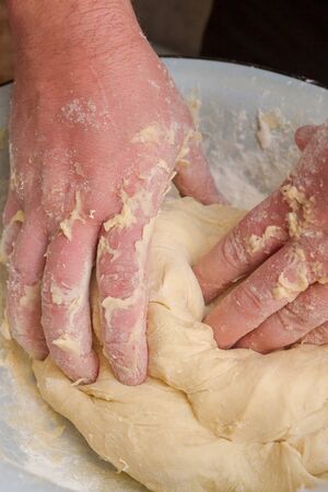 Cooking dough in a white plastic bowl at home
