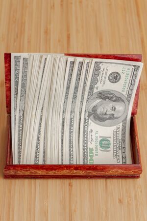American hundred dollar bills in large quantities in a wooden boxの写真素材