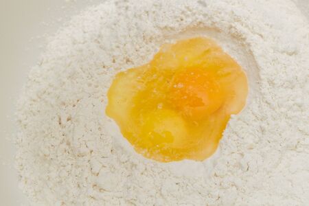 Cooking dough in a white plastic bowl at homeの写真素材