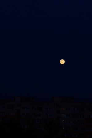 A bright moon in the black night skyの写真素材