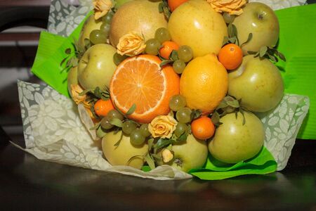 Fruit and floral green bouquet with apples and citrusの写真素材