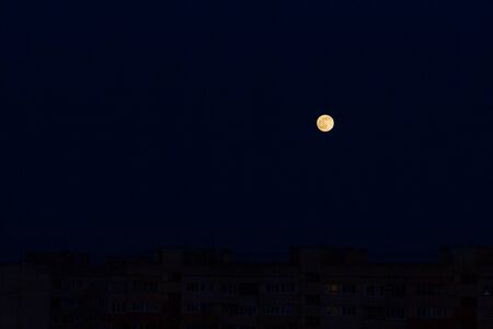 A bright moon in the black night skyの写真素材