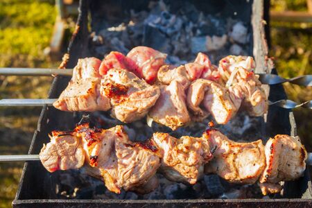 Fresh pork shish kebab is fried on skewers on the grillの写真素材