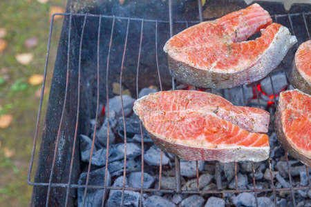 Large fish steaks fresh trout fried in spices on the grillの写真素材