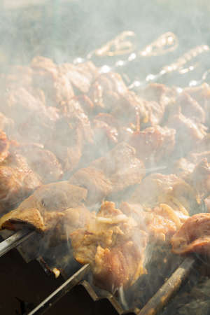 Shish Kebab made from pieces of pork is cooked on skewers on the grillの写真素材