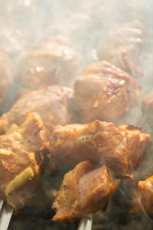 Shish Kebab made from pieces of pork is cooked on skewers on the grill