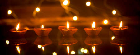 Happy Diwali - Diya lamps lit during diwali celebrationの写真素材