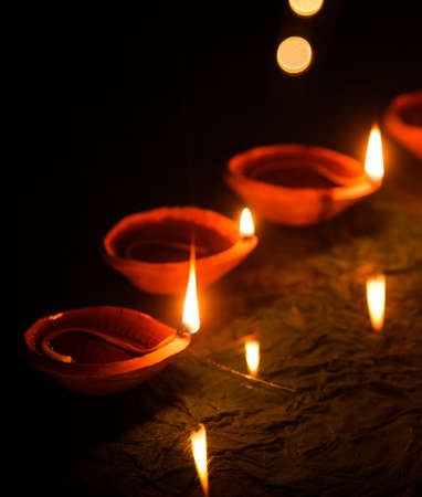 Happy Diwali - Diya lamps lit during diwali celebrationの写真素材