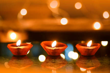 Happy Diwali - Diya lamps lit during diwali celebrationの写真素材