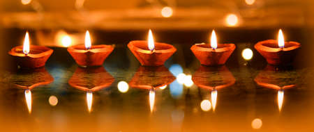 Happy Diwali - Diya lamps lit during diwali celebrationの写真素材