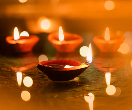 Happy Diwali - Diya lamps lit during diwali celebrationの写真素材