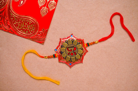 Indian Festival Raksha Bandhan, Rakhi on brown background.の写真素材