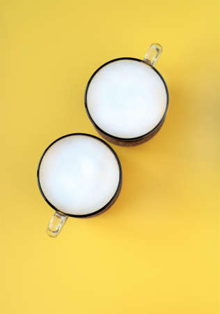 A cup of coffee on a yellow backgroundの写真素材