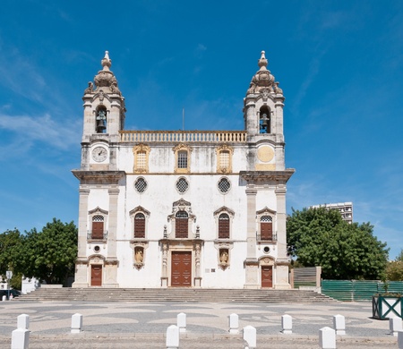 Church in Faro, Portugal, with two bell towers and a clockの写真素材