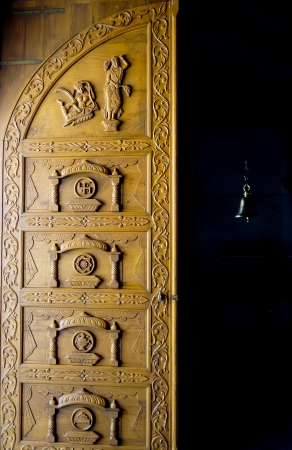 Wooden door of Jain temple in India with traditional ornament and symbolsの写真素材