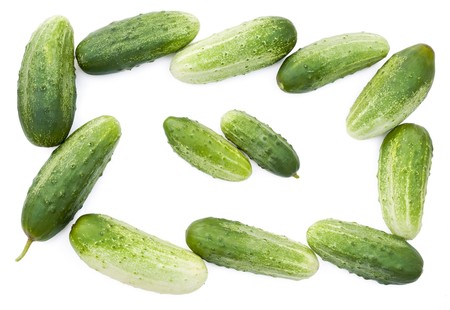 Fresh green cucumbers set background. Isolated on white. の写真素材