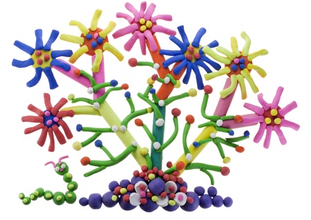 Children's collage- fantastic abstract plasticine flower on bed and caterpillar. Isolated on whiteの写真素材