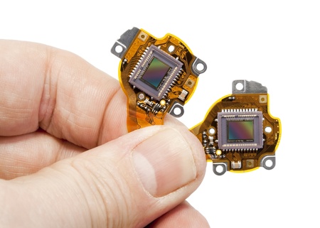 RGB  image  sensors from the  modern mass compact digital camera  in hand. Isolated on white with...