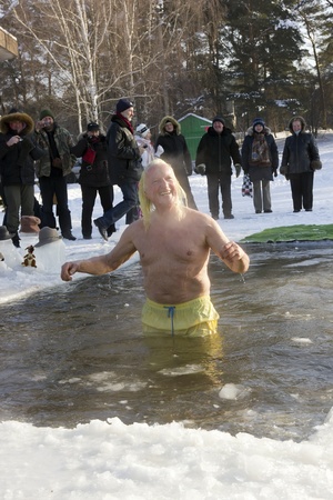VILNIUS, LITHUANIA â FEBRUARY 4: Fans of winter swimming take a bath in some ice water on February 4, 2012 in Vilnius, Lithuania. 
Sunny day, the air temperature is minus 20  Celsius degrees. The smiling boss of the club fans of ice water.のeditorial素材