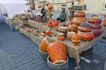 VILNIUS - MARCH 4: Fair devoted to the beginning of spring on March, 4th 2012 in Vilnius, Lithuania. A young man is selling their homemade ceramic productsのeditorial素材