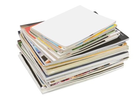 A stack of old forgotten glamorous mass  media magazines. Contains the pile and cover the top of the...