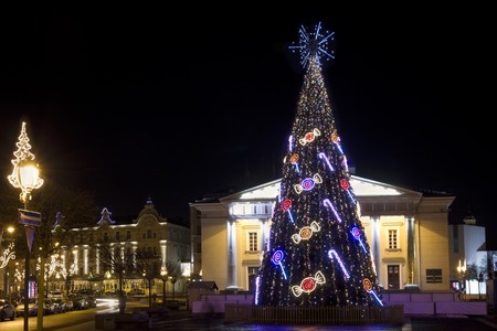 VILNIUS, LITHUANIA - DECEMBER 24: Christmas night on the Rotuse square of the old European city in Vilnius on December 24, 2013. Traditional decorated spruce. All the people sitting home and preparing for the holidayのeditorial素材