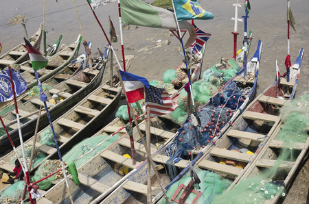 ACCARA GHANA  FEBRUARY 2014: Fishing boats and flags of the USA and other countries in Ghana in February 22 2014. In 1957 Ghana became the first African nation to declare independence from European colonization.のeditorial素材