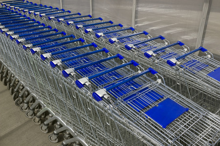 Empty shopping carts in the parking lot, no buyers. Concept of bad time of crisis. Perspective viewの写真素材