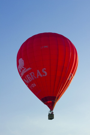 VILNIUS, LITHUANIA - MAY, 2014: Red balloon of the producer of elite Lithuanian  alcohol Stumbras  brand in May 24, 2014. Sunset sky. Stumbras  is founded in 1906 in the old capital of Lithuania -Kaunasのeditorial素材
