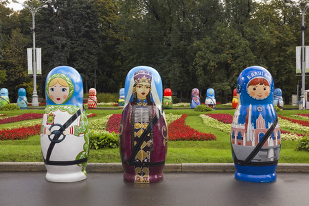 MOSCOW, RUSSIA - SEPTEMBER, 2013: Festival exhibition of large national peoples wooden dolls "Matryoshka" in the largest city "Sokolniki" park in September 18, 2013のeditorial素材