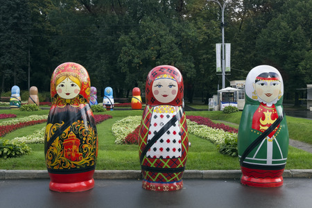 MOSCOW, RUSSIA - SEPTEMBER, 2013: Festival exhibition of large national peoples wooden dolls "Matryoshka" in the largest city "Sokolniki" park in September 18, 2013のeditorial素材