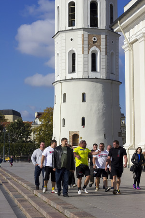 VILNIUS, LITHUANIA - OCTOBER 05, 2014: Big athletes walk on the old town. Prize winners of the European championship of athletes have a rest from sport. 31 super strong man participated in Lithuanian competitionsのeditorial素材