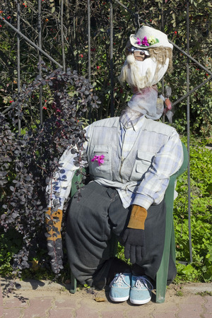 The handmade  naive effigy - dummy is dressed in clothes of the peasant and protects a kitchen garden from crowsの写真素材