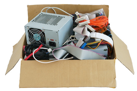 Cardboard box with the old used computer stuff  waste and garbage. Isolated with patchの写真素材