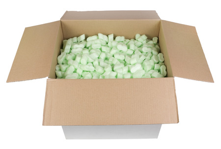 The big white cardboard box is filled with green bubbly plastic protective granules. Isolated with...